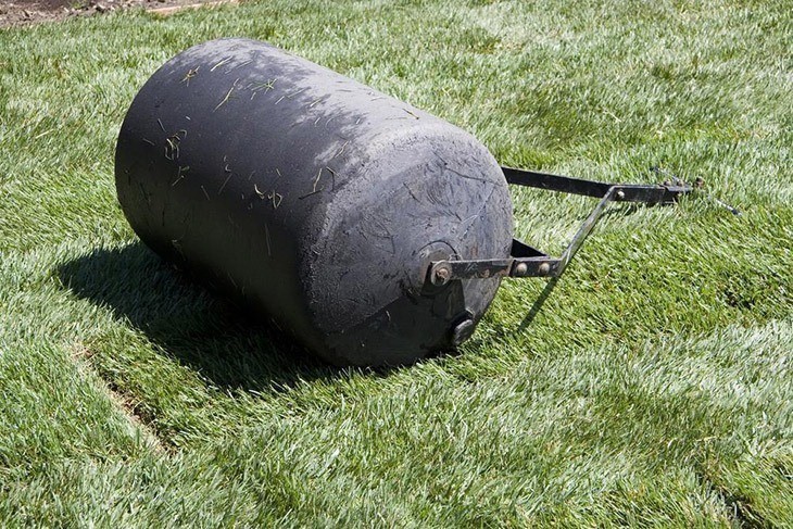 Lawn-roller-on-the-garden-how-to-lay-sod-over-existing-lawn