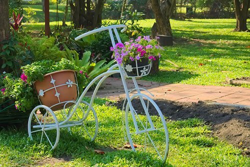 A-lovely-white-metal-bicycle-flower-pot-stand,-in-a-garden-park-in-Bangkok,-Thailand