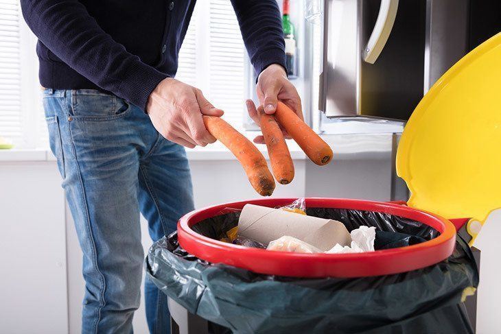 A-Person's-Hand-Throwing-Carrot-In-Dustbin-How-to-Tell-If-Carrots-Are-Bad-