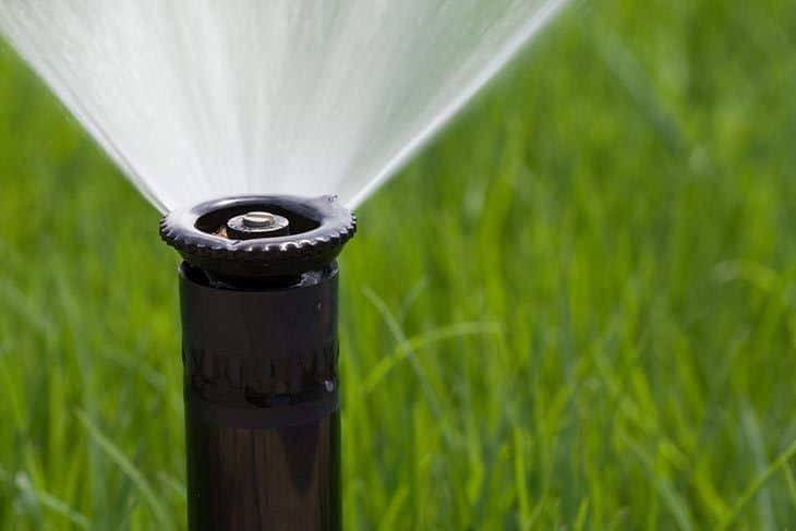 Detail-of-a-working-lawn-sprinkler-head-watering-the-grass